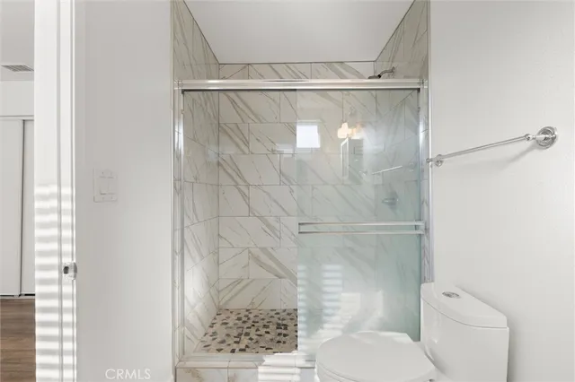 a bathroom with a glass shower door