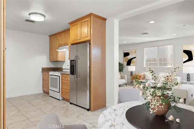 a kitchen with refrigerator and cabinets