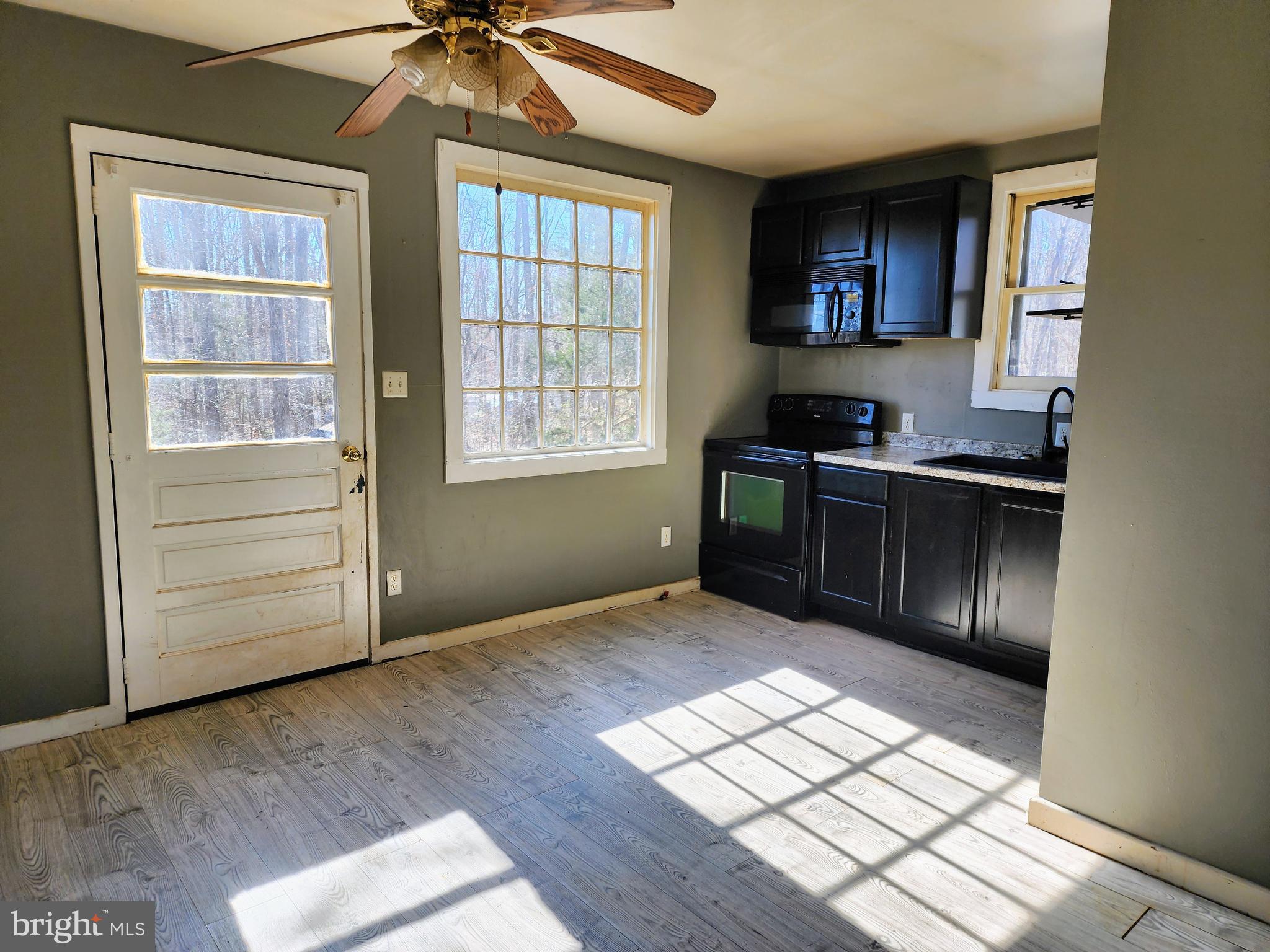 354 Carpenter Lane Mineral, VA 23117 - Photo 22 of 25 an empty room with wooden floor cabinet and windows