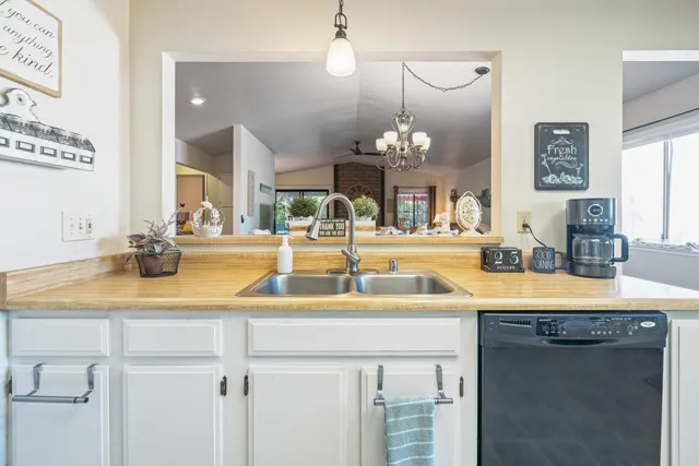 a bedroom with a bed a couch and a flat screen tv