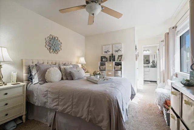 a bathroom with a granite countertop sink a mirror a toilet and shower