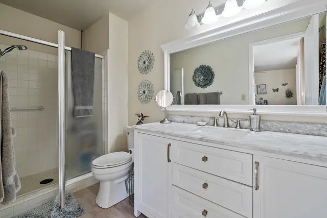 a bathroom with a toilet and a shower