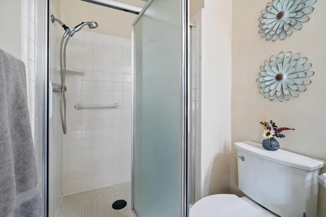 a bedroom with two beds and painting on the wall