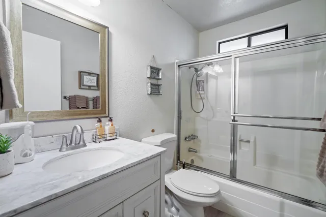 a bathroom with a glass shower door