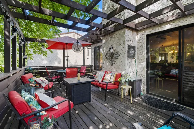 an outdoor sitting area with furniture and umbrella