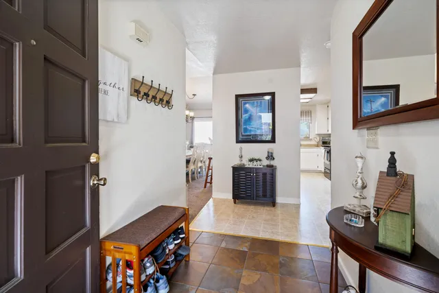 a view of a dining room with furniture a chandelier and window