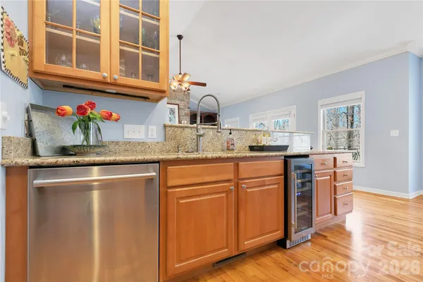 a kitchen with stainless steel appliances granite countertop a sink stove and cabinets