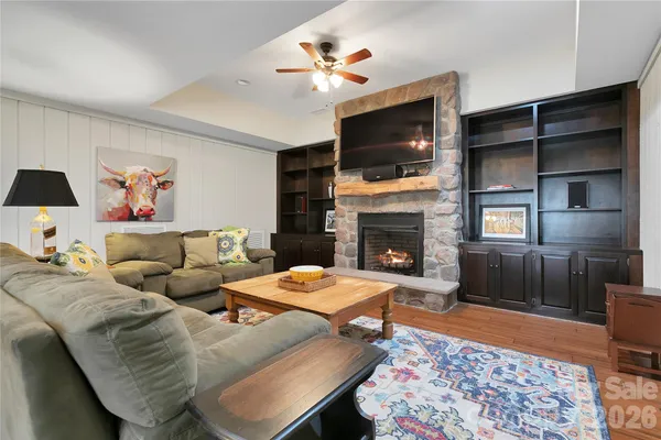 a living room with furniture fireplace and flat screen tv