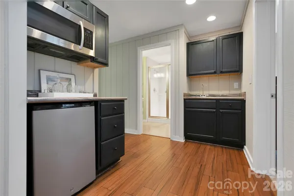 a kitchen with stainless steel appliances granite countertop a stove and a microwave