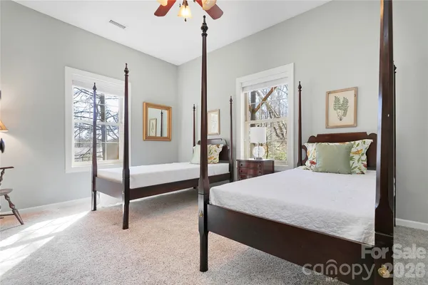 a bedroom with a large bed and a chandelier