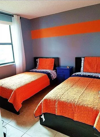 a bedroom with two beds and a night stand