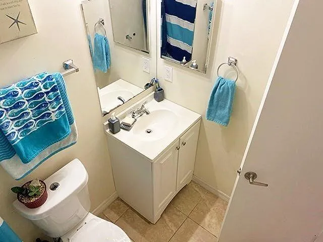 a bathroom with a sink mirror and toilet