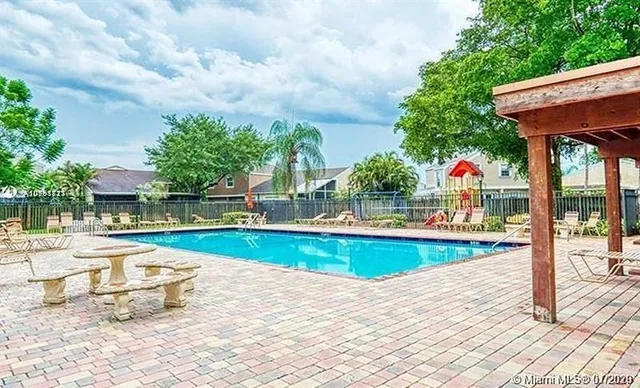 a view of swimming pool with sitting area and furniture