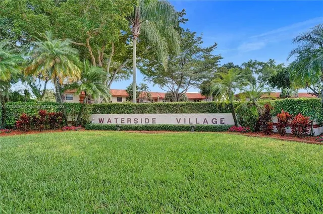 a view of a park with a bench and trees