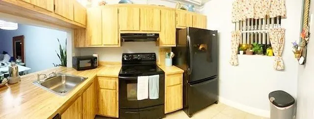 a kitchen with a refrigerator and a stove