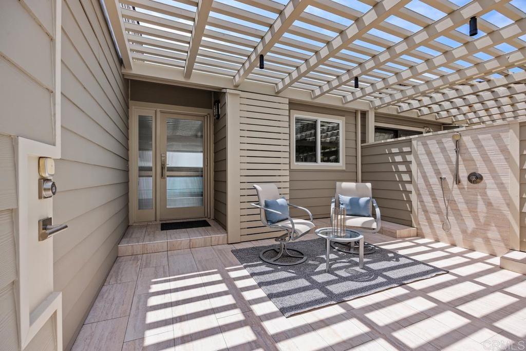 1856 Parliament Road Encinitas, CA 92024 - Photo 6 of 42 a view of a patio with a table and chairs and wooden floor