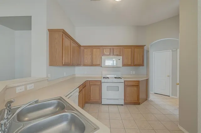 a kitchen with a sink and a refrigerator