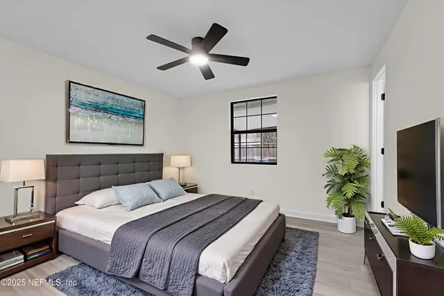 a bedroom with a bed and a flat screen tv