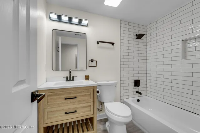 a bathroom with a sink toilet a mirror and shower