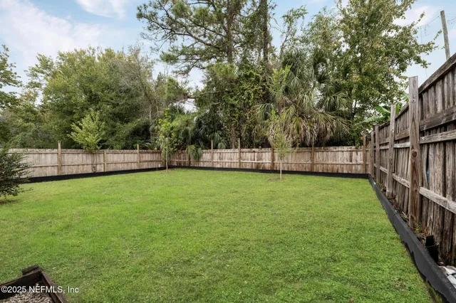 a view of yard with deck and trees