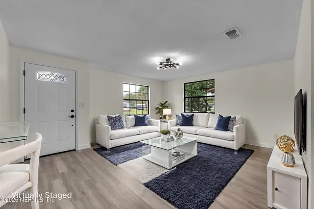 a living room with furniture and a rug