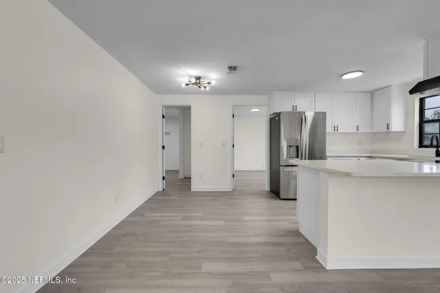 a kitchen with stainless steel appliances a refrigerator and a stove top oven