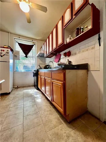 a view of a kitchen with stainless steel appliances and cabinets