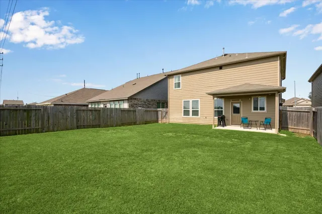 a view of a house with a yard and porch