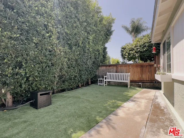 a view of a chair and table in the backyard