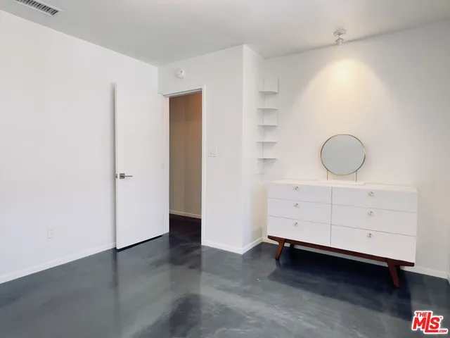 a view of hallway with wooden floor