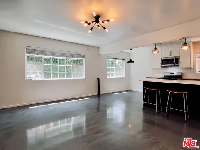 a workspace with furniture window and wooden floor