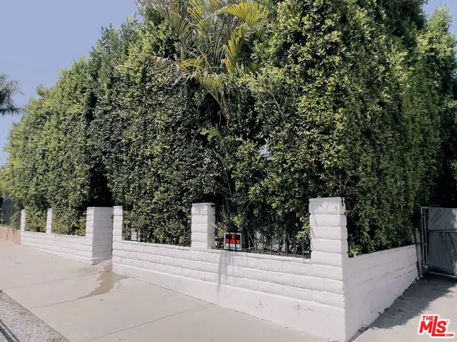 a front view of a house with a parking space