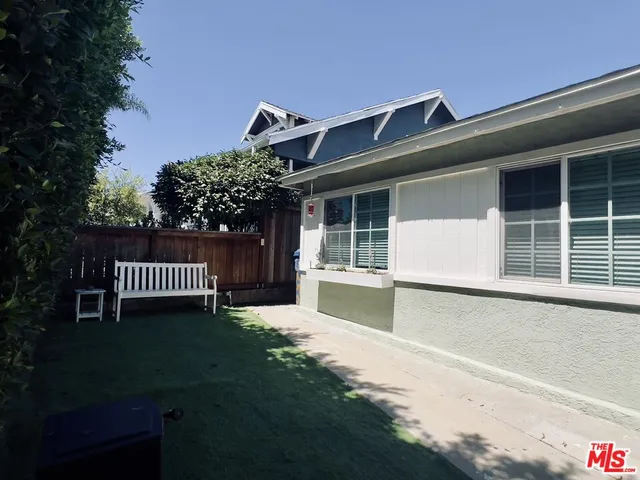 a backyard of a house with outdoor seating