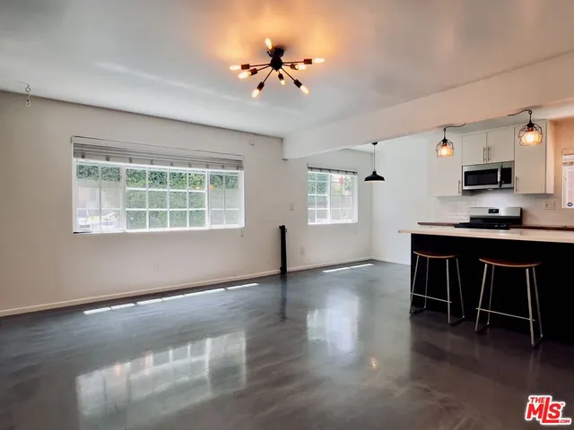 a workspace with furniture window and wooden floor