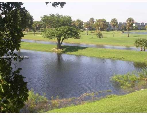 4055 West McNab Road, Unit H303 Pompano Beach, FL 33069 - Photo 2 of 12 a view of a park with large trees