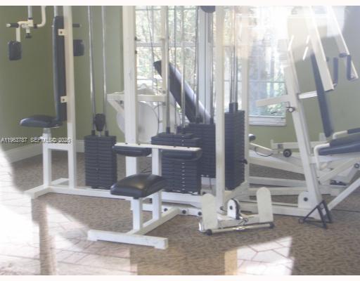 4055 West McNab Road, Unit H303 Pompano Beach, FL 33069 - Photo 8 of 12 a view of living room filled with furniture and floor to ceiling window