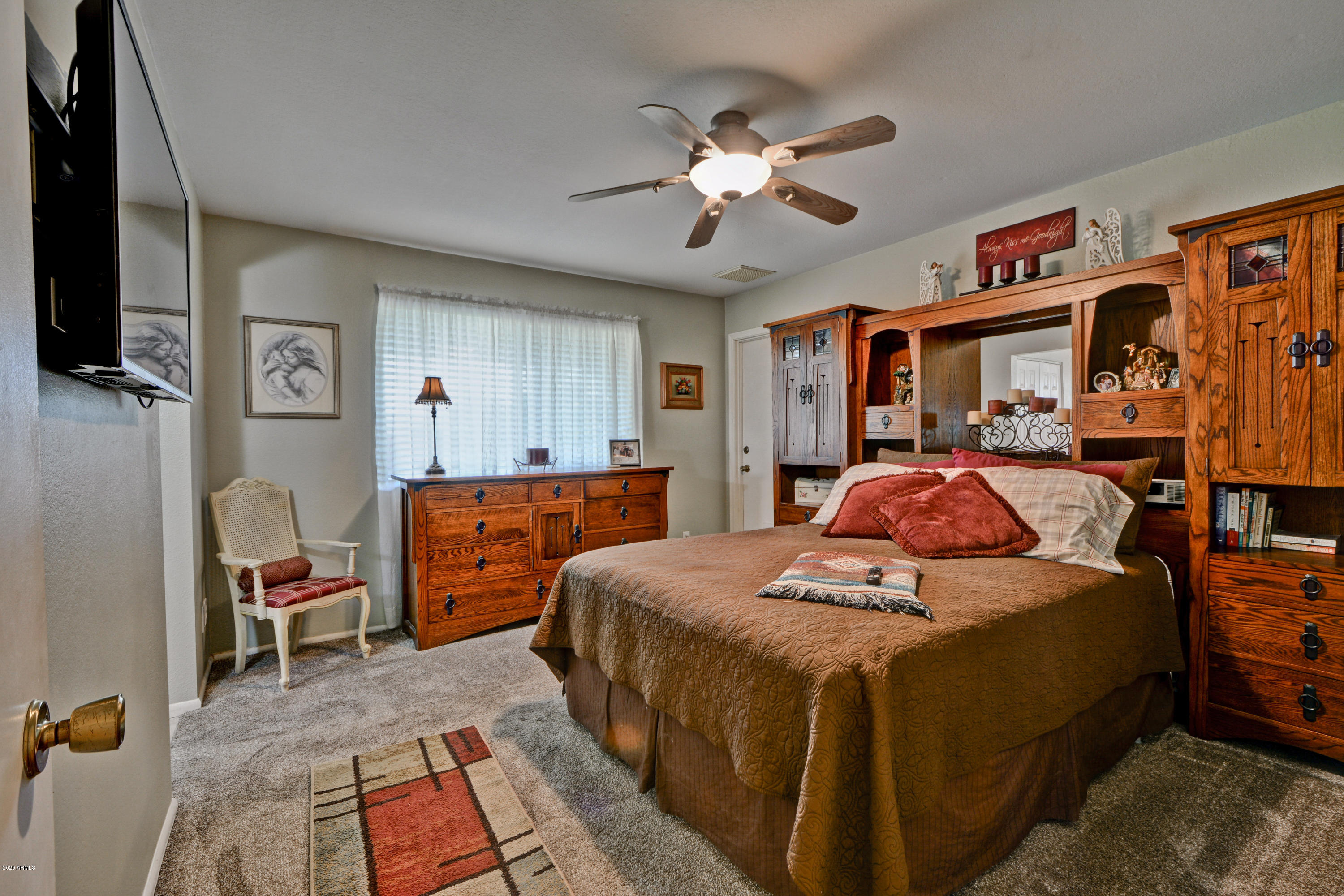 3209 West Cactus Road Phoenix, AZ 85029 - Photo 20 of 35 a bed room with furniture and a chandelier