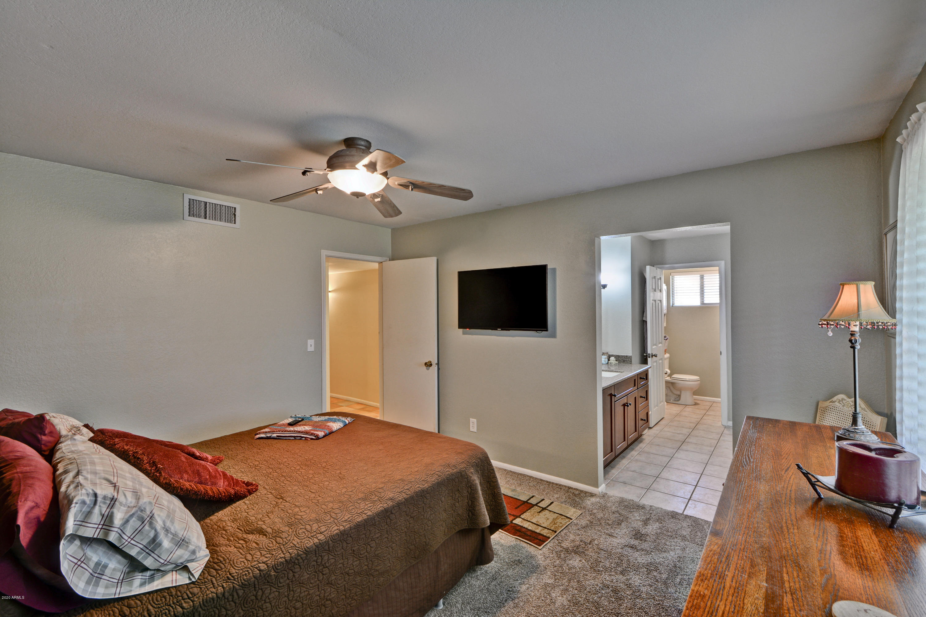 3209 West Cactus Road Phoenix, AZ 85029 - Photo 21 of 35 a bedroom with a bed and a chandelier