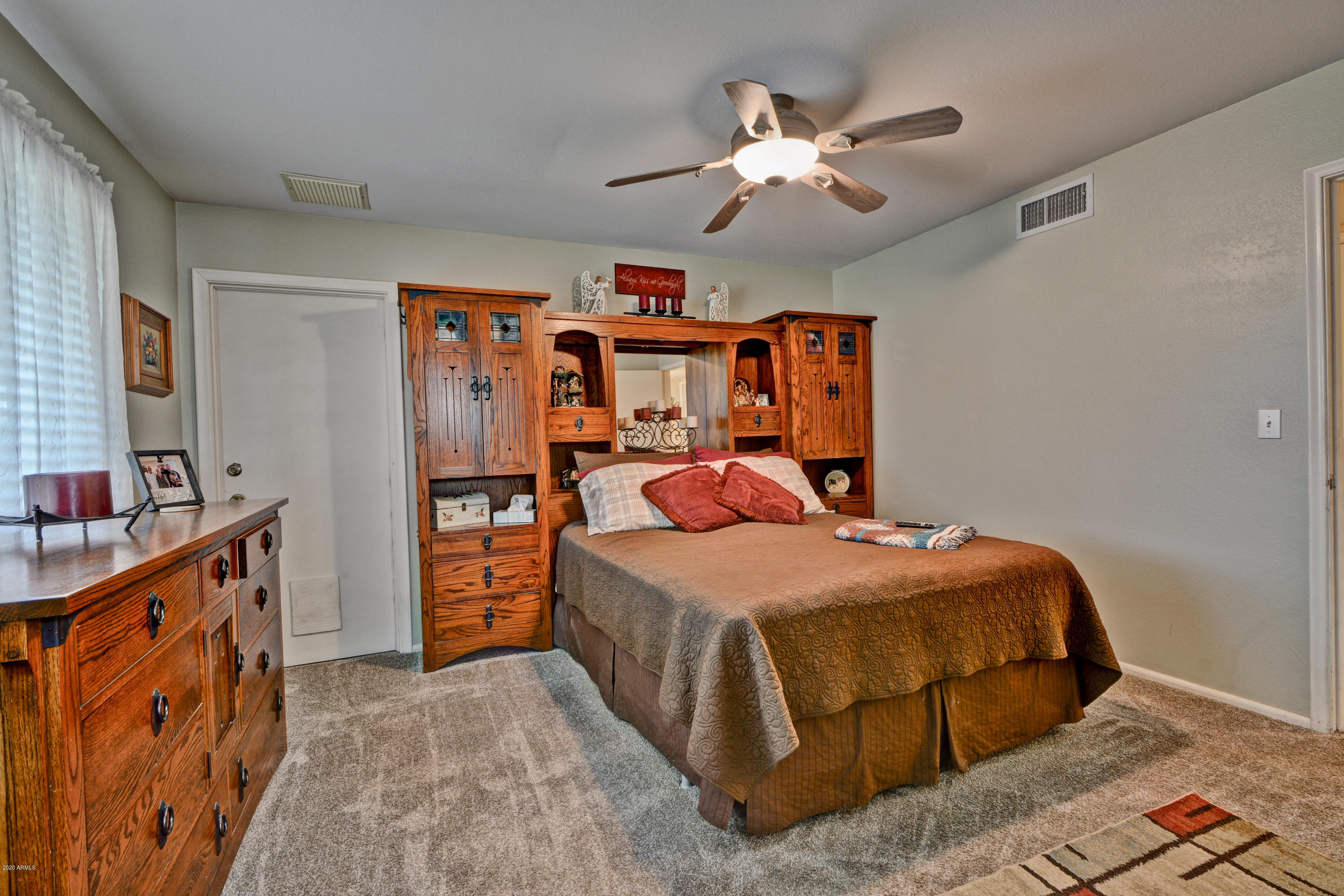 3209 West Cactus Road Phoenix, AZ 85029 - Photo 22 of 35 a bedroom with a bed and a chandelier