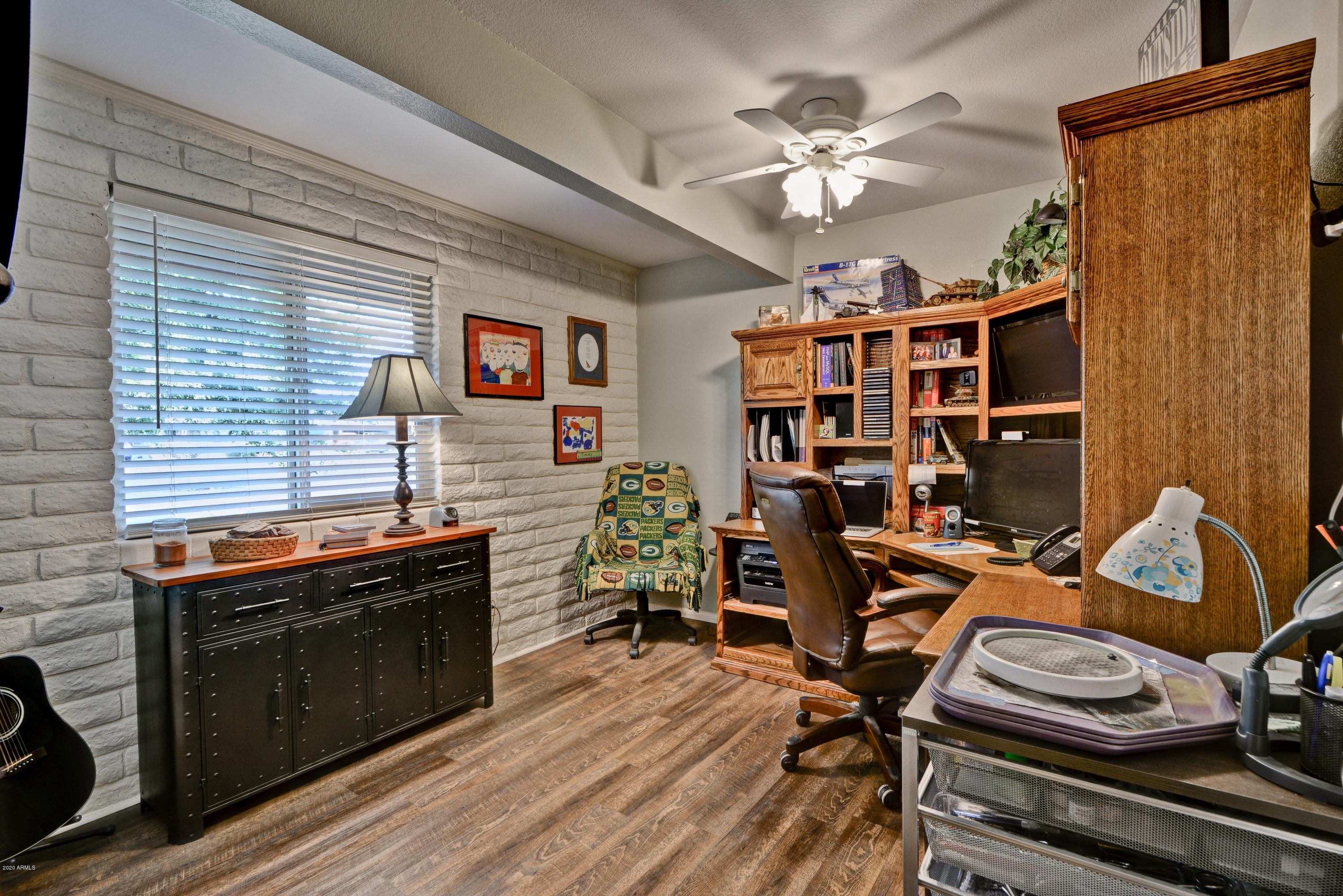 3209 West Cactus Road Phoenix, AZ 85029 - Photo 28 of 35 a work room with furniture and wooden floor