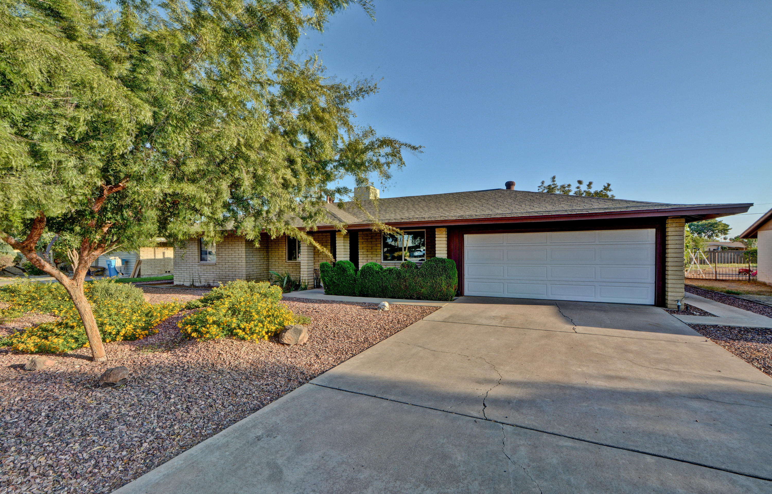 3209 West Cactus Road Phoenix, AZ 85029 - Photo 3 of 35 a front view of a house with a yard and a garage