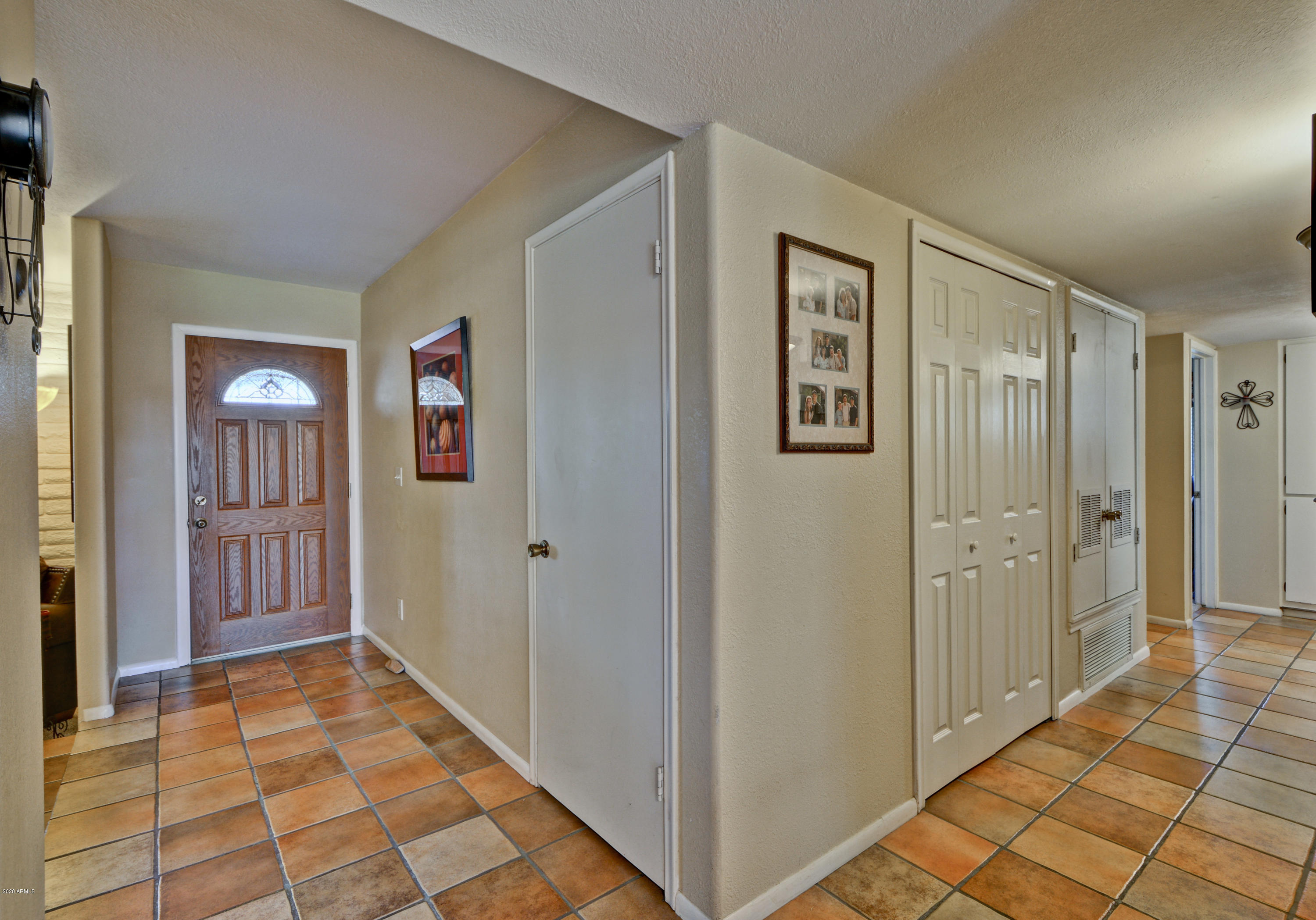 3209 West Cactus Road Phoenix, AZ 85029 - Photo 4 of 35 a view of a hallway with windows and bathroom