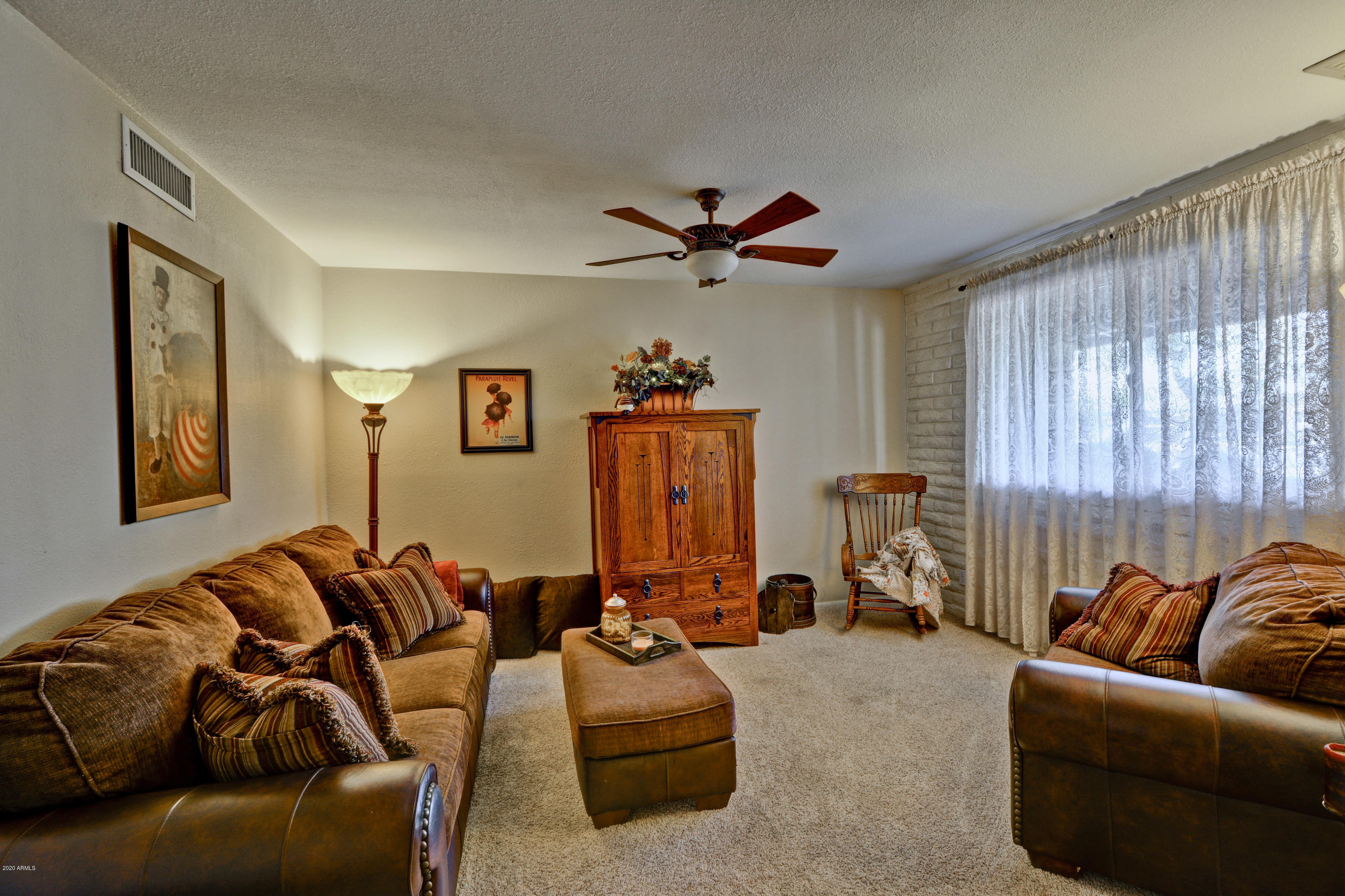 3209 West Cactus Road Phoenix, AZ 85029 - Photo 5 of 35 a living room with furniture ceiling fan and a window