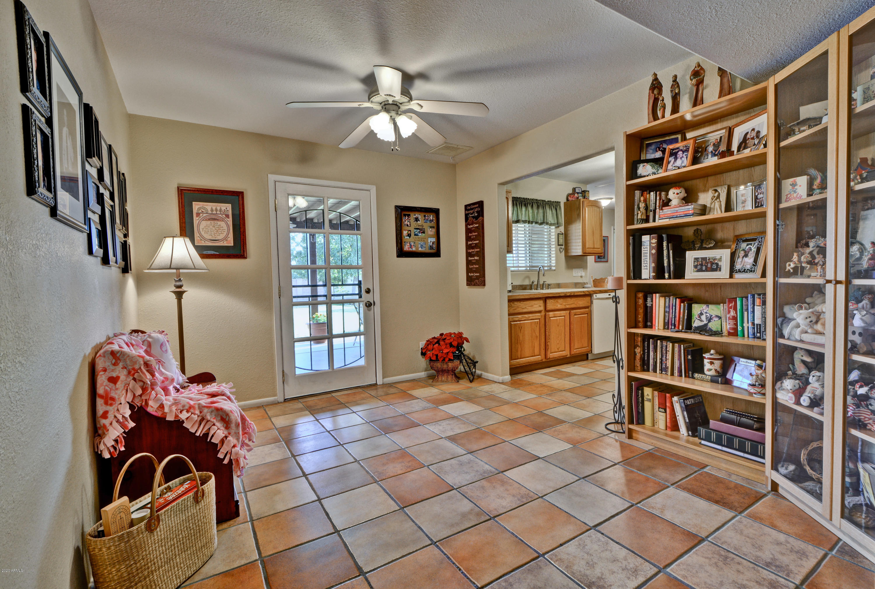 3209 West Cactus Road Phoenix, AZ 85029 - Photo 7 of 35 a bed room with a bed and a book shelf