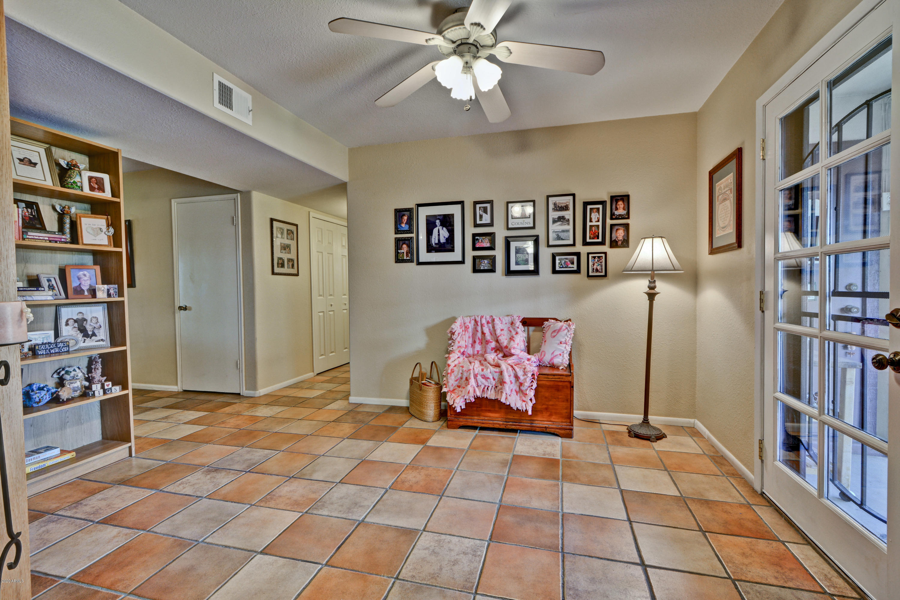 3209 West Cactus Road Phoenix, AZ 85029 - Photo 8 of 35 a view of a bedroom with furniture and book shelf