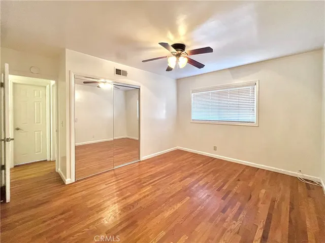 a view of an empty room and wooden floor