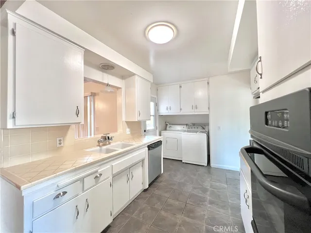 a kitchen with a sink stove and cabinets