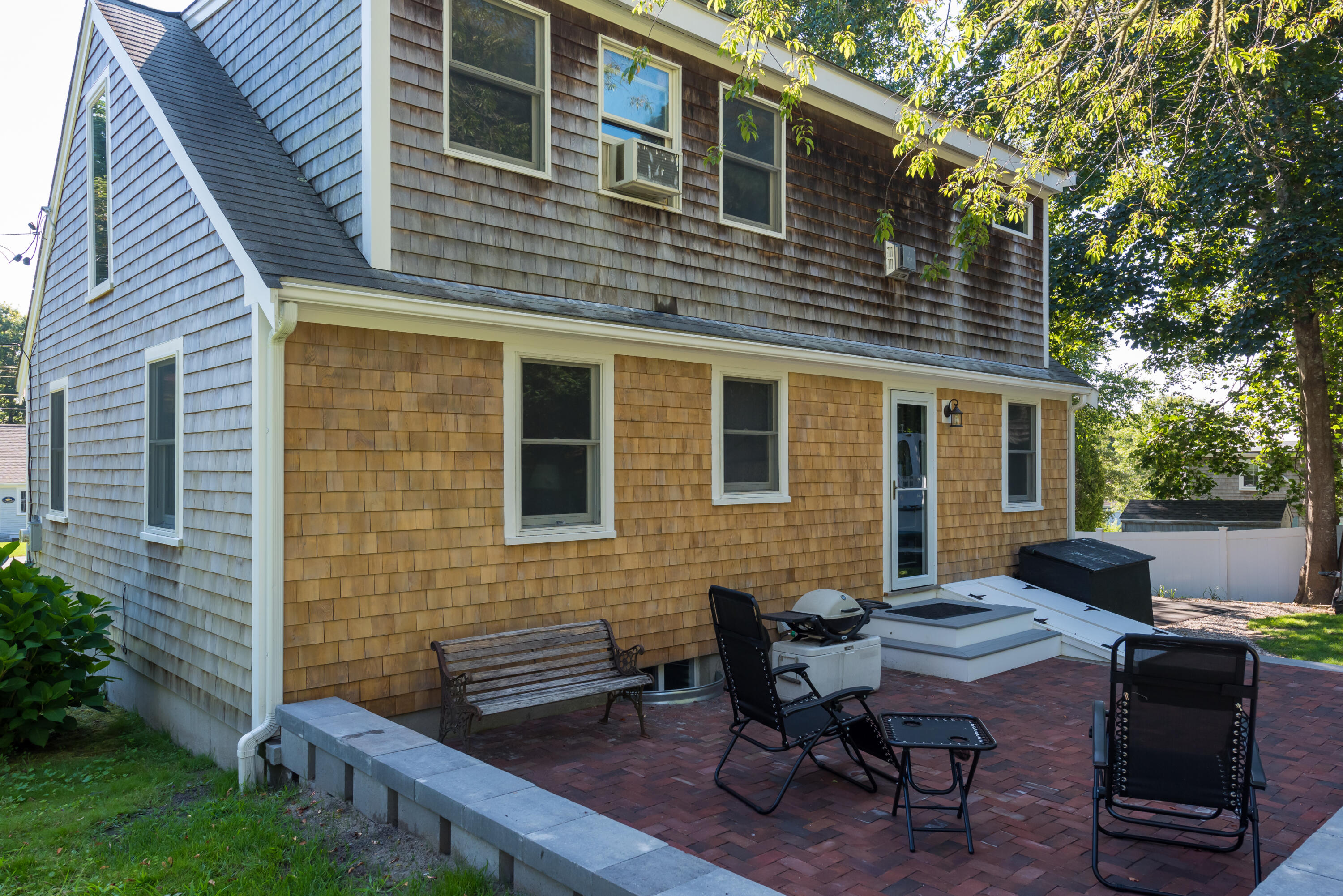 59 Nob Hill Road Chatham, MA 02633 - Photo 19 of 24 a view of a backyard with a table and chairs