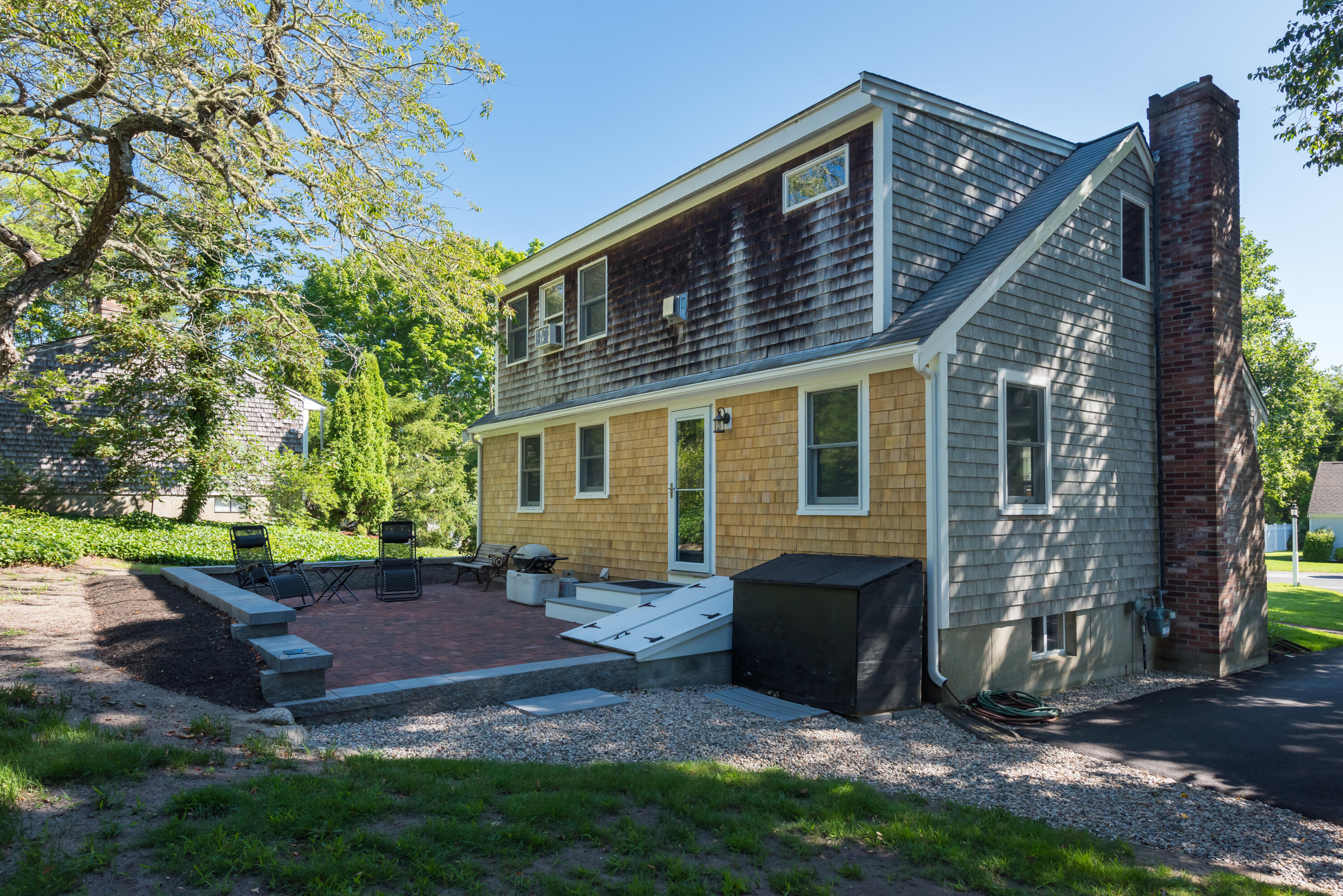 59 Nob Hill Road Chatham, MA 02633 - Photo 21 of 24 a view of backyard with table and chairs and potted plants