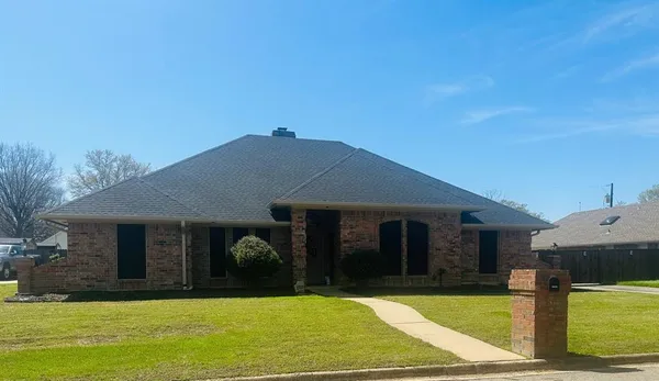 a view of a dining room with furniture and a chandelier